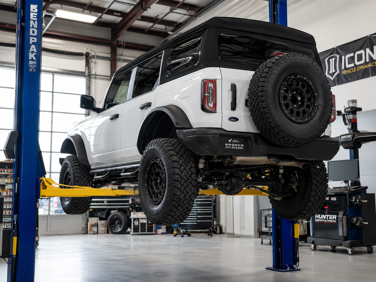 Lifted 4x4 on a lift inside the shop during installation