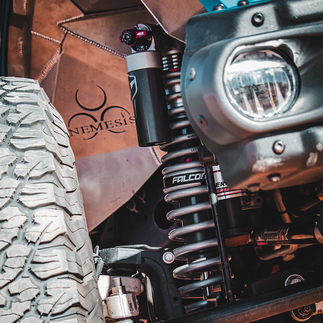 Aftermarket coilover and suspension components installed under a lifted 4x4