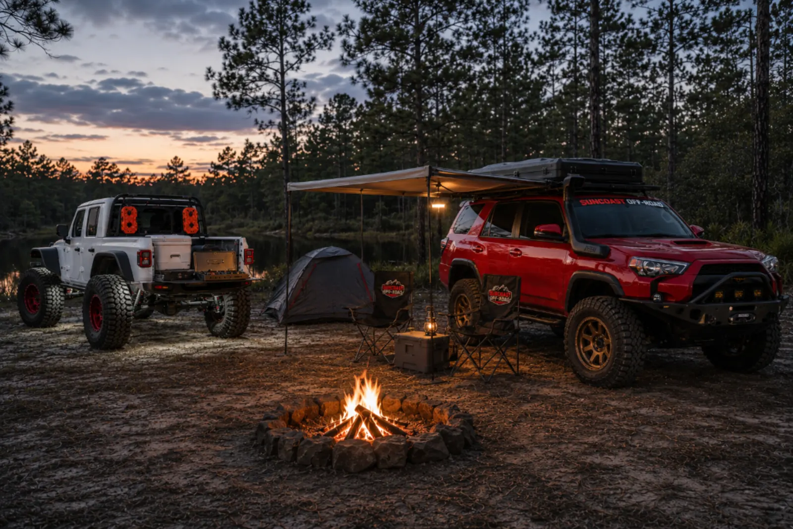 Lifted Jeep Wrangler with off-road tires parked on a ridge at golden hour