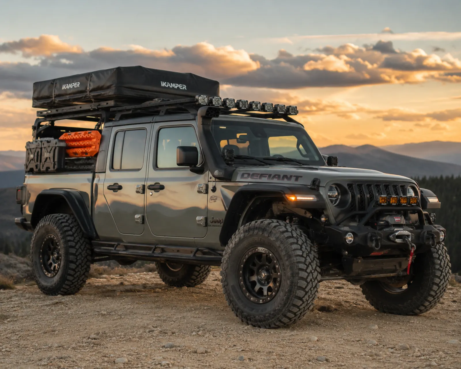 Overland-built 4x4 with roof rack and rooftop tent in a Florida pine setting